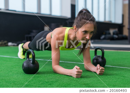 Fit woman doing plank exercise working on Fit woman doing plank exercise working on 20160493