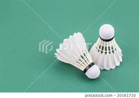 Two new badminton shuttlecock on green court mat Two new badminton shuttlecock on green court mat 20161710
