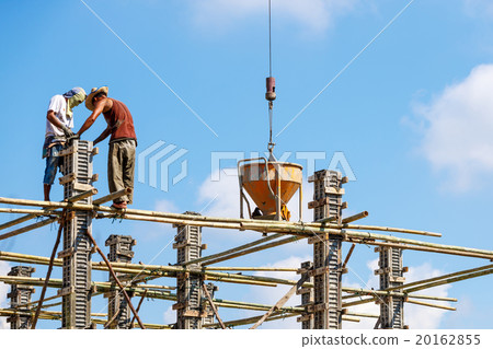 Worker working in construction on blue sky Worker working in construction on blue sky 20162855