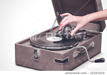 Old portable gramophone with female hand Old portable gramophone with female hand 20165829