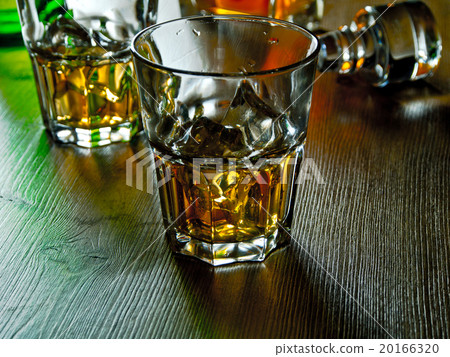 Whiskey on the rocks on a wooden table 20166320