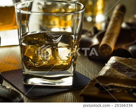 Whiskey on the rocks on a wooden table 20166336