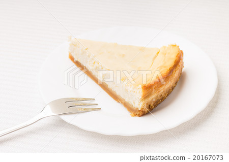 Piece of cheesecake on white saucer Piece of cheesecake on white saucer 20167073