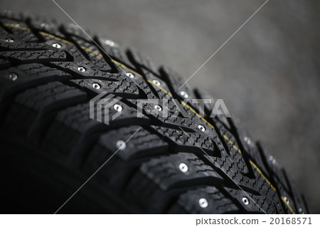 Studded tire on a gray background 20168571