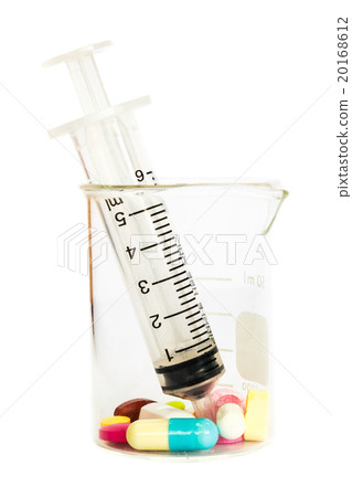 syringe in beaker and group of drugs 20168612
