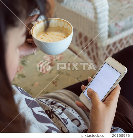 woman drinking hot coffee in cafe 20168976