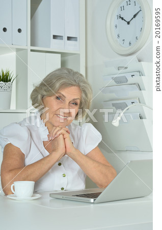 Elderly woman working on laptop 20169595