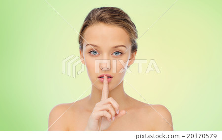beautiful young woman holding finger on lips beautiful young woman holding finger on lips 20170579