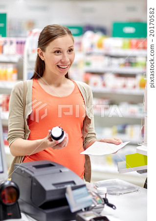 happy pregnant woman with medication at pharmacy happy pregnant woman with medication at pharmacy 20170582