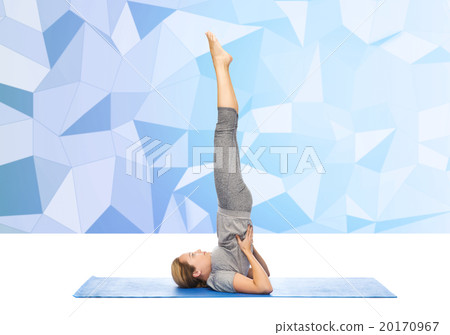 woman making yoga in shoulderstand pose on mat woman making yoga in shoulderstand pose on mat 20170967