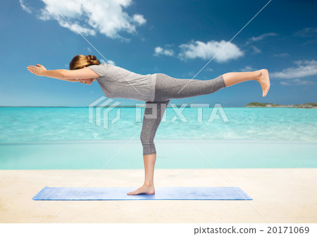 woman making yoga warrior pose on mat woman making yoga warrior pose on mat 20171069
