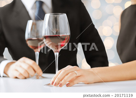 hands of couple with diamond ring and wine glasses hands of couple with diamond ring and wine glasses 20171119