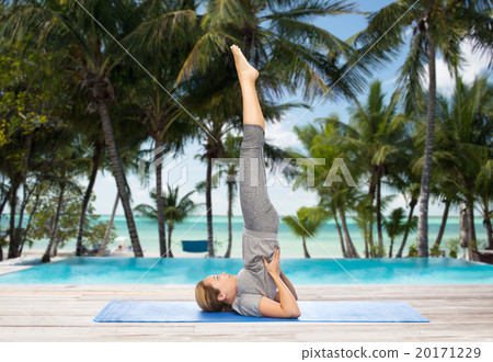 woman making yoga in shoulderstand pose on mat 20171229