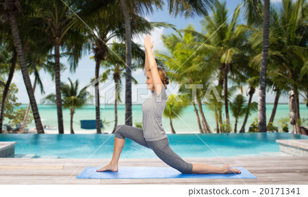 happy woman making yoga in low lunge over beach 20171341