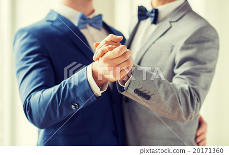 close up of happy male gay couple dancing 20171360