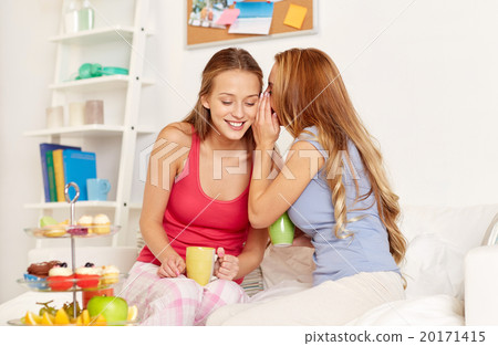 young women drinking tea and gossiping at home young women drinking tea and gossiping at home 20171415
