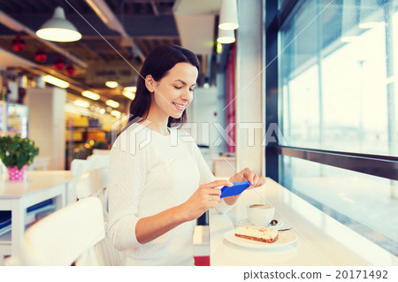smiling woman with smartphone and coffee at cafe 20171492