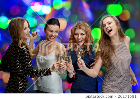 happy women clinking champagne glasses over lights 20171581