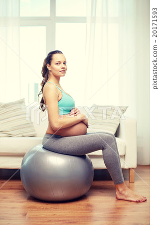happy pregnant woman exercising on fitball at home 20171593