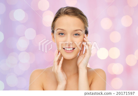 smiling young woman touching her face smiling young woman touching her face 20171597