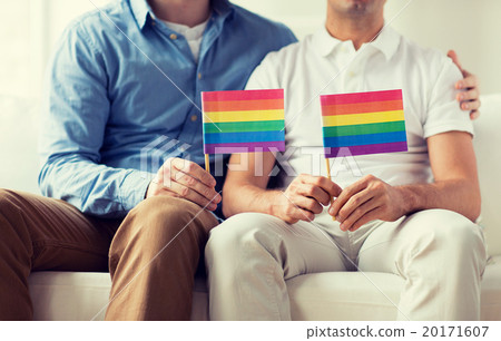 close up of male gay couple holding rainbow flags 20171607