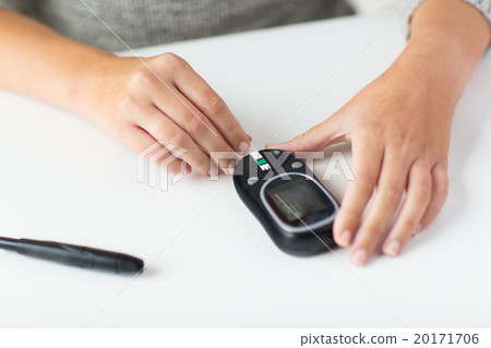 close up of woman making blood test by glucometer 20171706