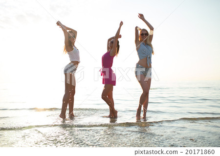 happy female friends dancing on beach 20171860