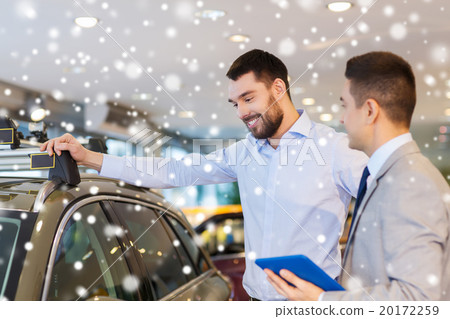 happy man with car dealer in auto show or salon happy man with car dealer in auto show or salon 20172259