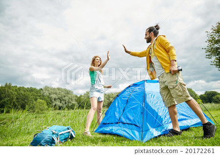 happy couple setting up tent outdoors happy couple setting up tent outdoors 20172261