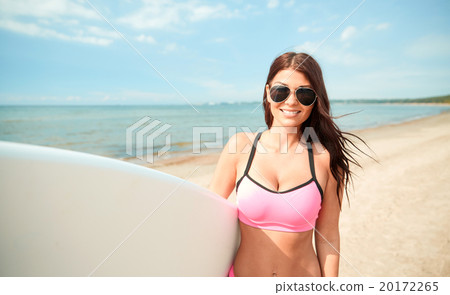 smiling young woman with surfboard on beach smiling young woman with surfboard on beach 20172265
