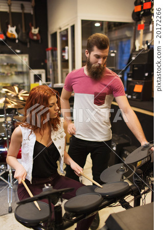 man and woman with drum kit at music store 20172266