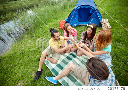 happy friends with tent and drinks at campsite happy friends with tent and drinks at campsite 20172476