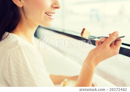 close up of woman eating cake at cafe or home close up of woman eating cake at cafe or home 20172482