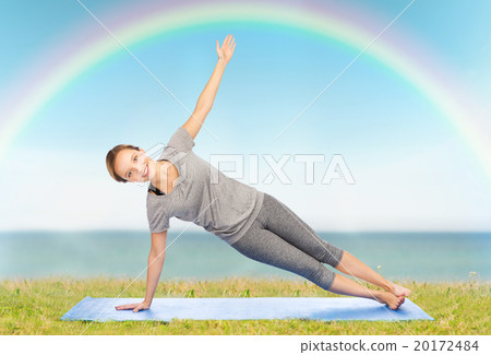 woman making yoga in side plank pose on mat woman making yoga in side plank pose on mat 20172484