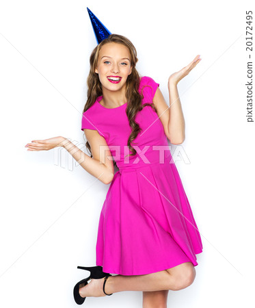 happy young woman or teen girl in party cap happy young woman or teen girl in party cap 20172495