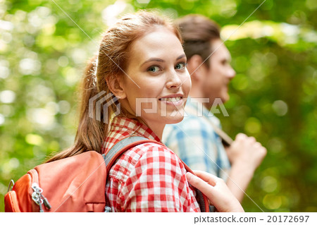 group of smiling friends with backpacks hiking 20172697