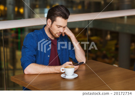 man with smartphone and coffee at restaurant 20172734
