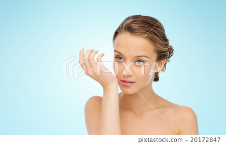 woman smelling perfume from wrist of her hand 20172847