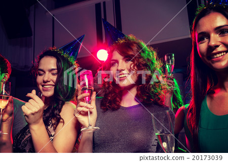 smiling friends with glasses of champagne in club 20173039