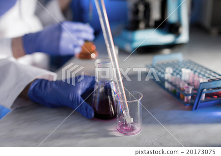 close up of scientists making test in lab 20173075