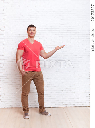 Young Man Open Palm To Copy Space Standing Over 20173207