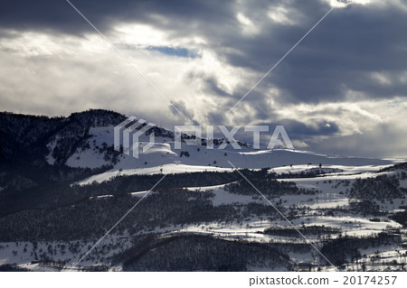 Village in winter mountains and storm clouds 20174257
