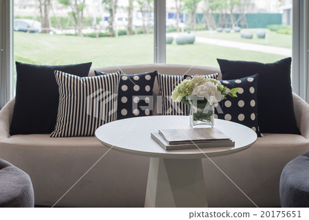 vase of flower on round table with pillows 20175651