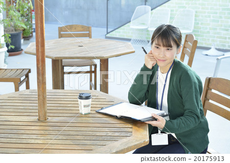 A young woman taking a note with a pen A young woman taking a note with a pen 20175913