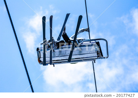 Bottom view of skiers have a fun on chair lift 20177427