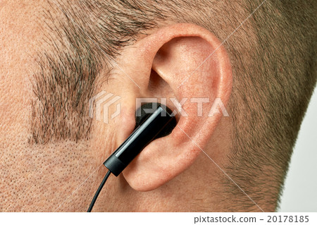 Ear with earphone closeup 20178185