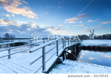 bridge via river to windmill in winter 20178543