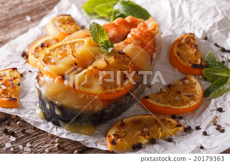 Juicy salmon steak baked with oranges closeup Juicy salmon steak baked with oranges closeup 20179363