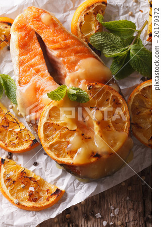 baked salmon with oranges close-up on the table baked salmon with oranges close-up on the table 20179372