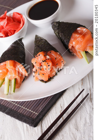 Temaki salmon on a plate close-up. Vertical 20180345